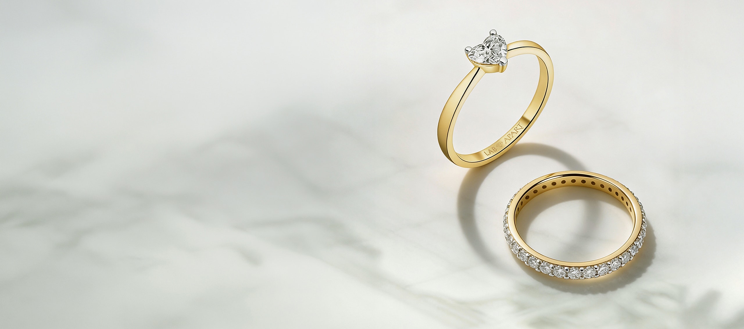 Dva zlaté prsteny zdobené laboratorními diamanty