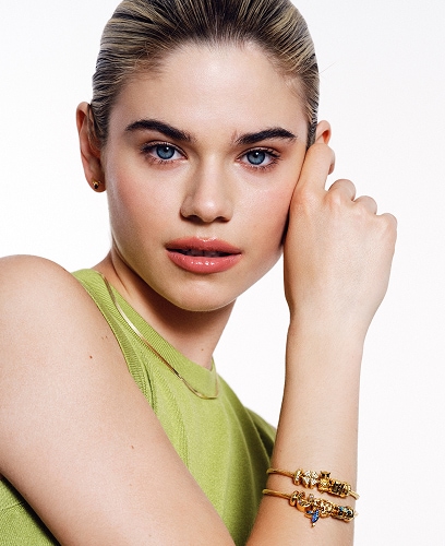 A model showing off silver-plated bracelets from the Beads Collection with a Good luck motif
