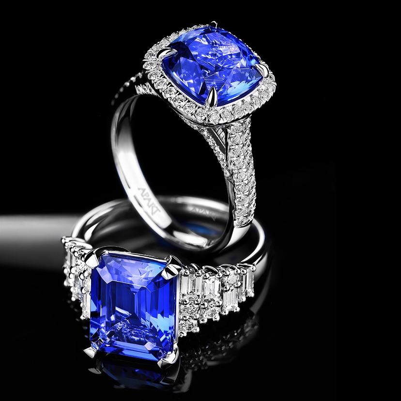 Two white gold rings, set with large cushion and emerald-cut blue tanzanite stones and diamond