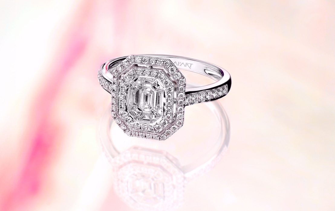 A white gold ring with one large diamond and many small ones