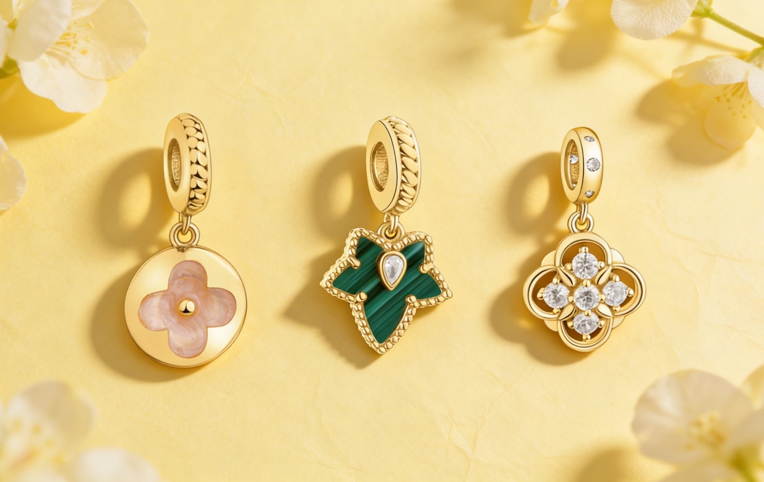 Three pendants from a collection of beads on a yellow spring background with white flowers