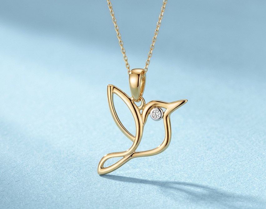 Gold pendant – hummingbird on a blue background