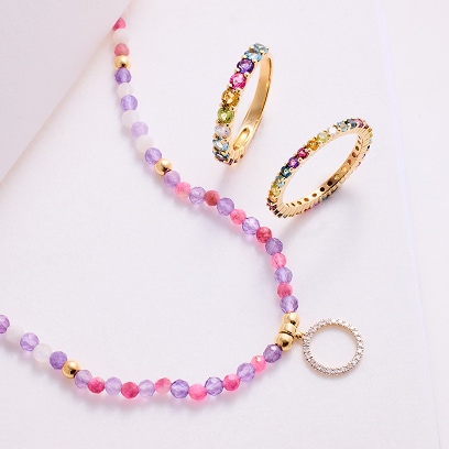 necklace with colored stones and a gold ring