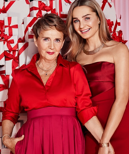 Małgorzata Socha with an older lady in a red dress