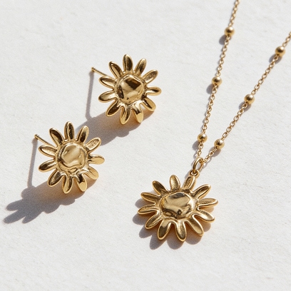 Gold earrings in the shape of a sun and a gold necklace with a sun pendant