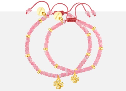 Two bracelets with gold elements decorated with pink beads