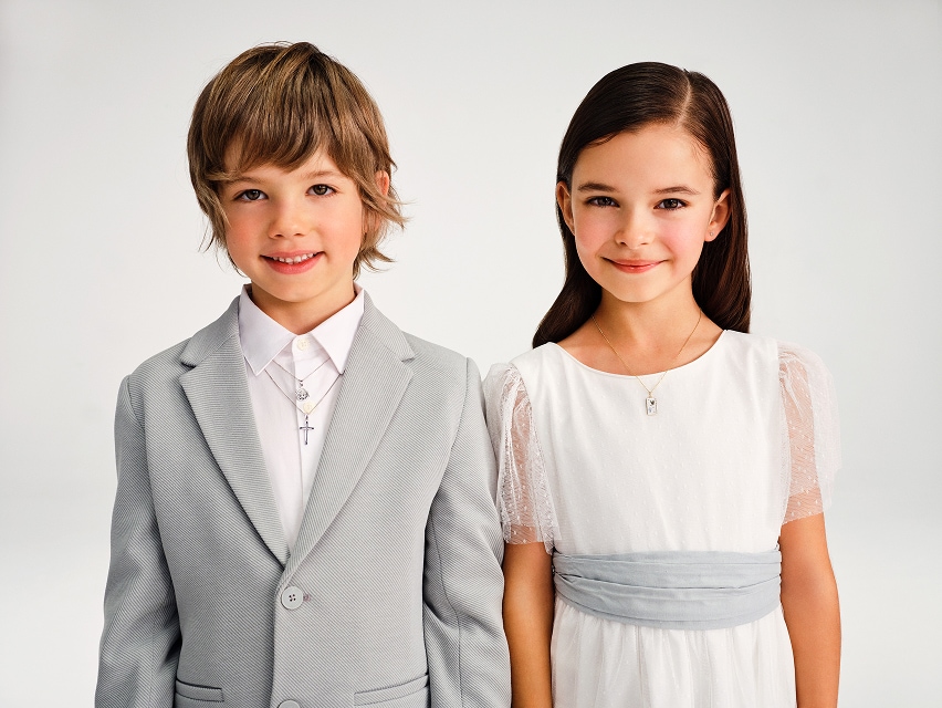 two children presenting jewellery from the Medals and crosses collection