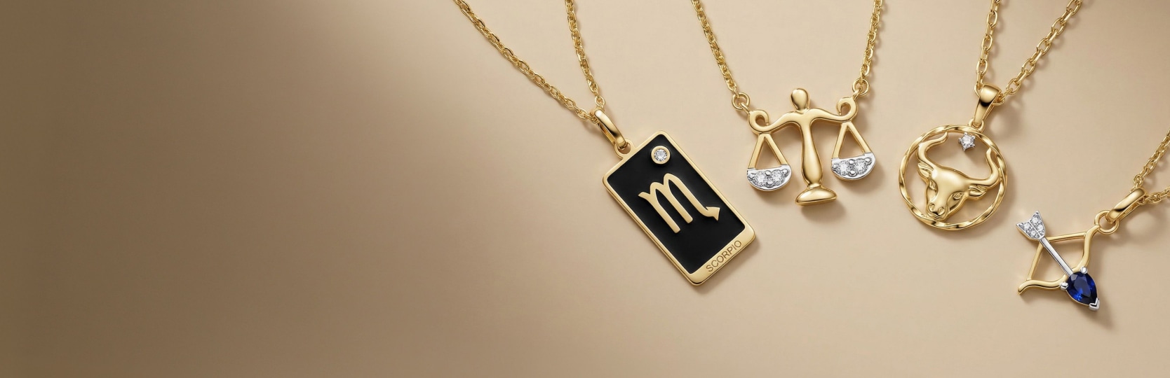 cztery zawieszki ze znakiem zodiaku: skorpion, waga, byk i strzelec