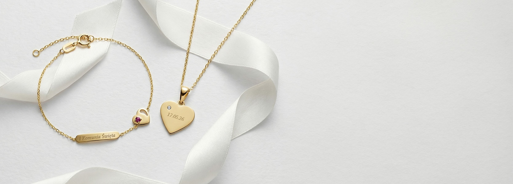 Złota biżuteria z grawerunkiem - bransoletka oraz łańcuszek z zawieszką