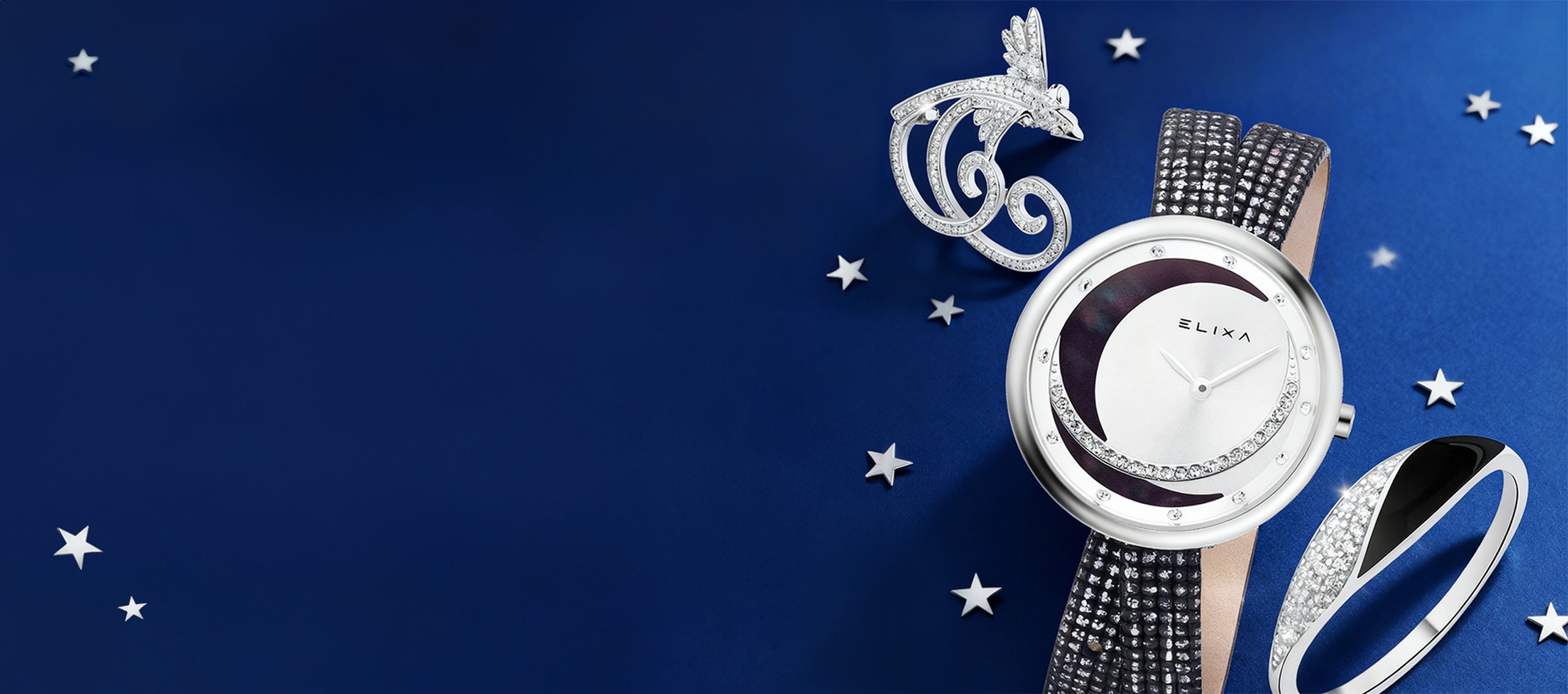 banner Noworoczne wyprzedaże do 70% - srebrna broszka, srebrny zegarek marki Elixa, srebrny pierścionek z cyrkoniami i emalią na granatowym tle