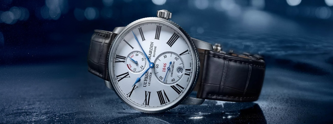 Elegancki zegarek męski Ulysse Nardin z białą tarczą, niebieskimi wskazówkami i ciemnobrązowym skórzanym paskiem